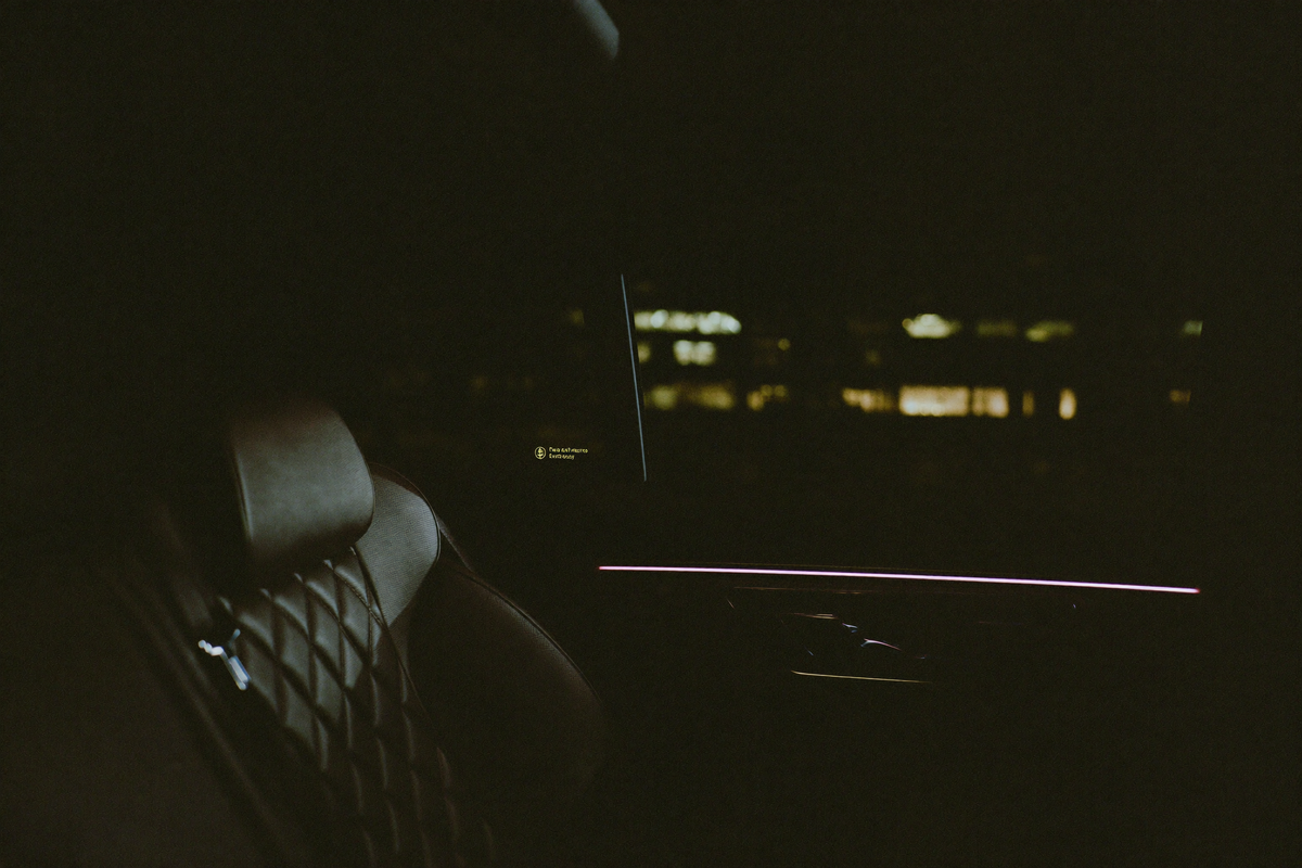 View from inside a luxury car cabin through a darkened window at night, cabin privacy